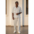 Male model wearing white pinstripe polo and trouser two-piece set
