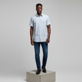 Nigerian male model wearing white sky blue stripe short-sleeved shirt, front view