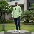 Nigerian male model wearing men's lime green long-sleeve button-down casual shirt, garden setting