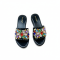 Ghost mannequin pair view of black patent leather wedge slide mules with multicolour gemstone rhinestone floral strap
