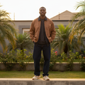 Nigerian male model wearing caramel brown denim collar utility field jacket — full body street style