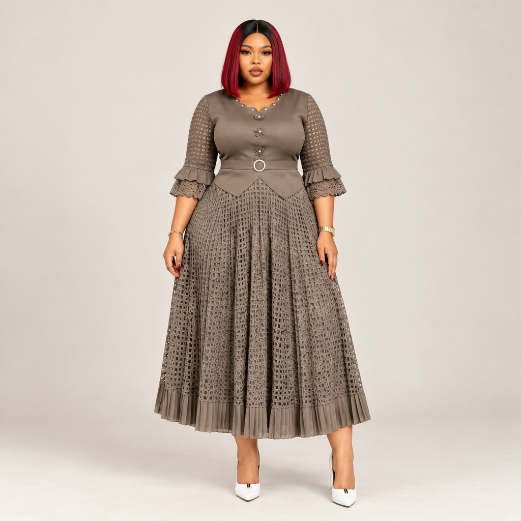 Black Nigerian model wearing a taupe geometric gown with patterned sleeves and a belted waist