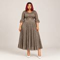 Black Nigerian model wearing a taupe geometric gown with patterned sleeves and a belted waist