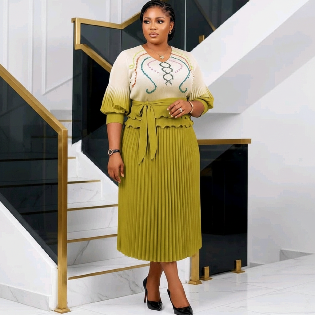 Nigerian woman wearing cream and olive green ombre embroidered top and pleated midi skirt set
