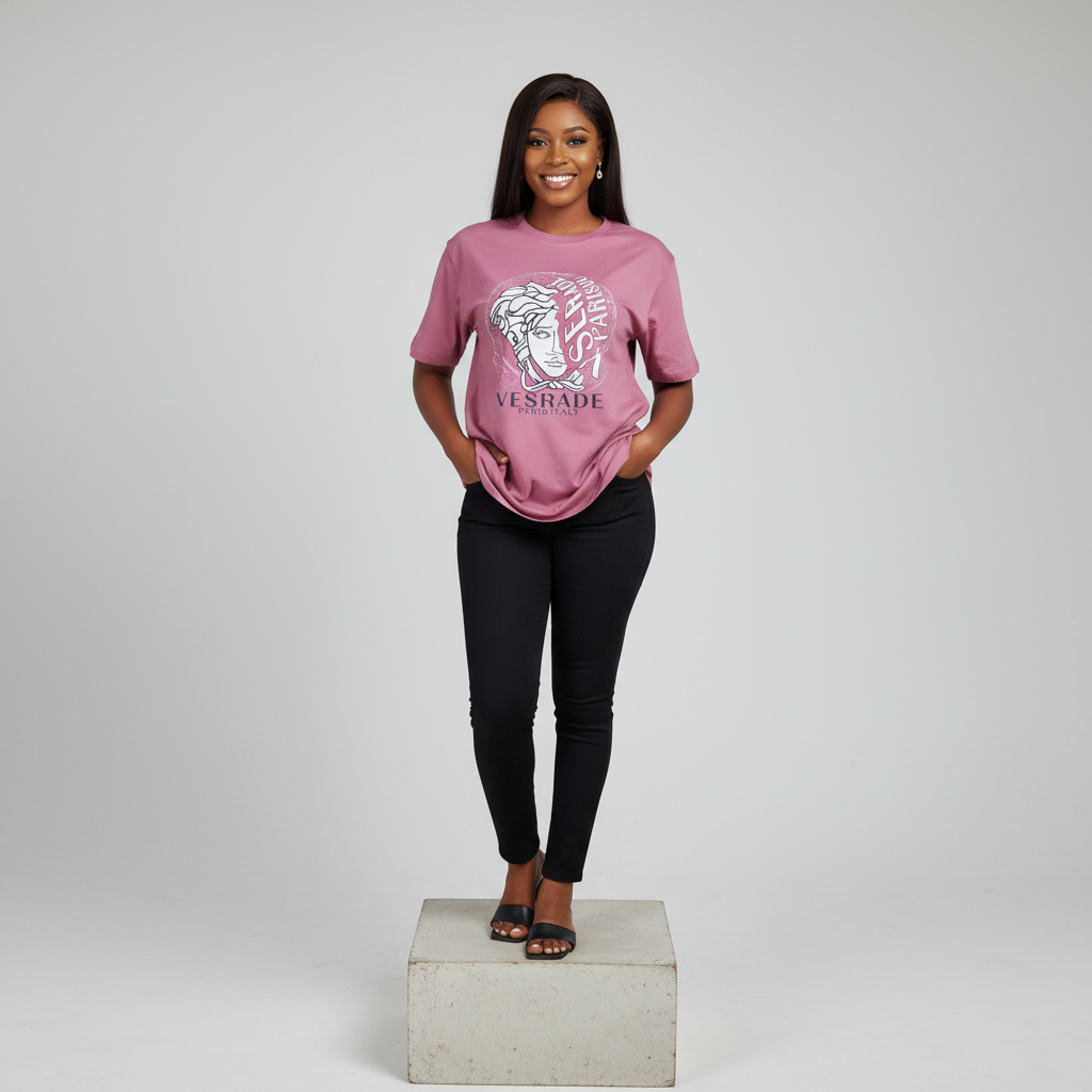 Nigerian female model front view wearing dusty pink mythological face graphic T-shirt