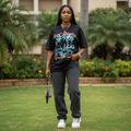 Nigerian female model wearing black tropical paradise vacation graphic oversized tee – front view