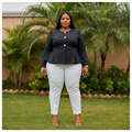Nigerian female model wearing women's plus-size black peplum jacket – lifestyle shot