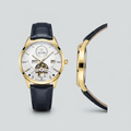 Gold-tone open-heart watch with white dial and dark navy textured strap shown from the front and side