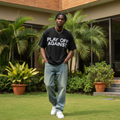 Nigerian male model wearing black play off against statement oversized tee – front view