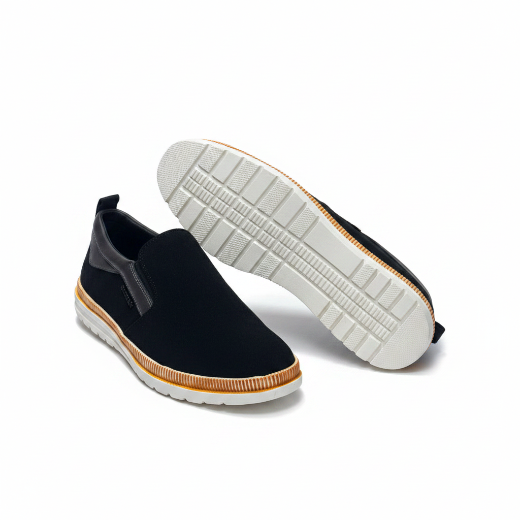 Men's black suede slip-on sneaker pair front and sole view on white background, amber midsole band visible