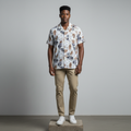 Nigerian male model wearing white botanical leaf print short-sleeved shirt