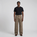 Full-body male model wearing washed brown panelled trousers