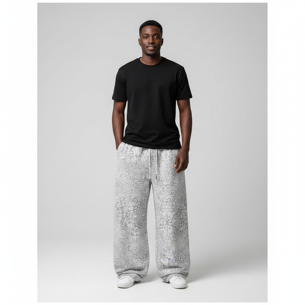 Model wearing light grey leopard print baggy joggers with a black t-shirt