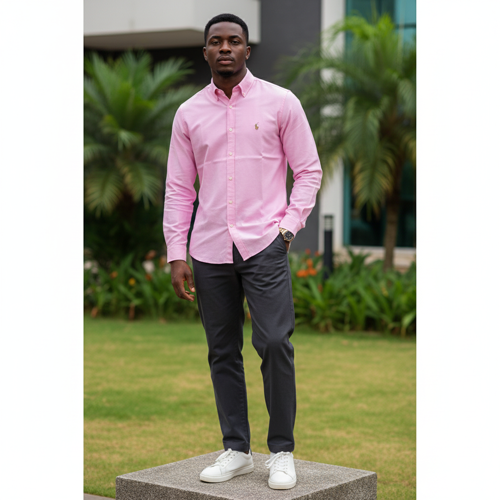 Nigerian male model wearing men's candy pink long-sleeve button-down casual shirt, garden setting