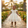 Young Nigerian toddler girl wearing champagne rosette lace puff sleeve tulle party dress