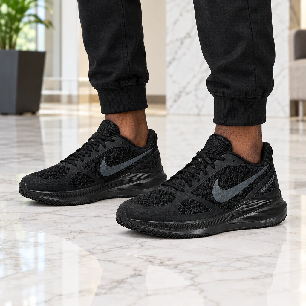 Man wearing triple black mesh running sneakers