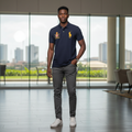 Nigerian male model wearing navy polo shirt with gold crest embroidery