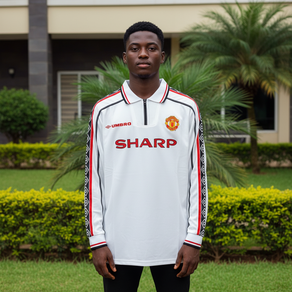 White long-sleeve retro football jersey with diamond tape sleeves — Nigerian male model front view
