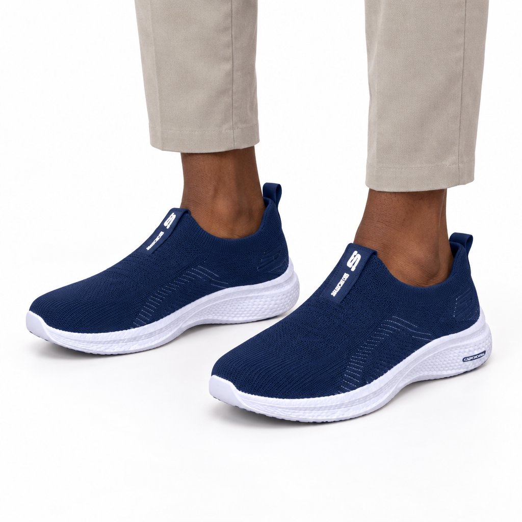 Both navy sneakers worn ankle-down on plain white background