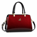 Red gradient structured handbag with black handles on white background