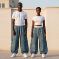 Male and female models wearing blue rhinestone cross balloon joggers