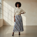Nigerian model wearing geometric print pleated maxi skirt