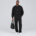 Black male model wearing a black teddy print sweatshirt