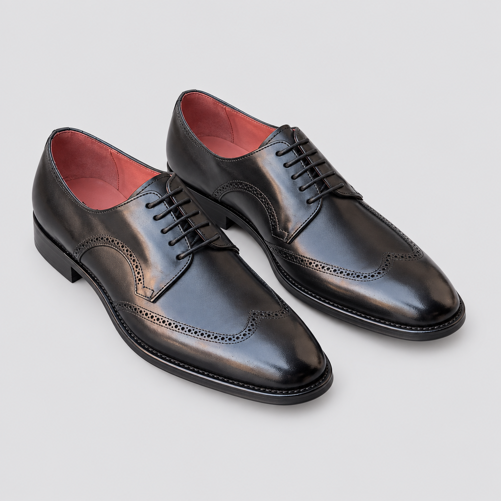 Pair of black men's lace-up shoes with wingtip detailing