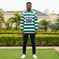 Green and white hooped long-sleeve retro football jersey — Nigerian male model front view