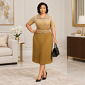 Adult Black woman wearing gold collared pleated dress