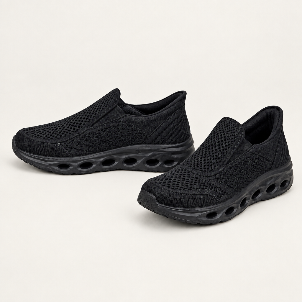 Black mesh slip-on sneakers with sculpted soles and oval cutouts
