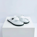 Men's white leather black emblem thong sandals pair on white platform