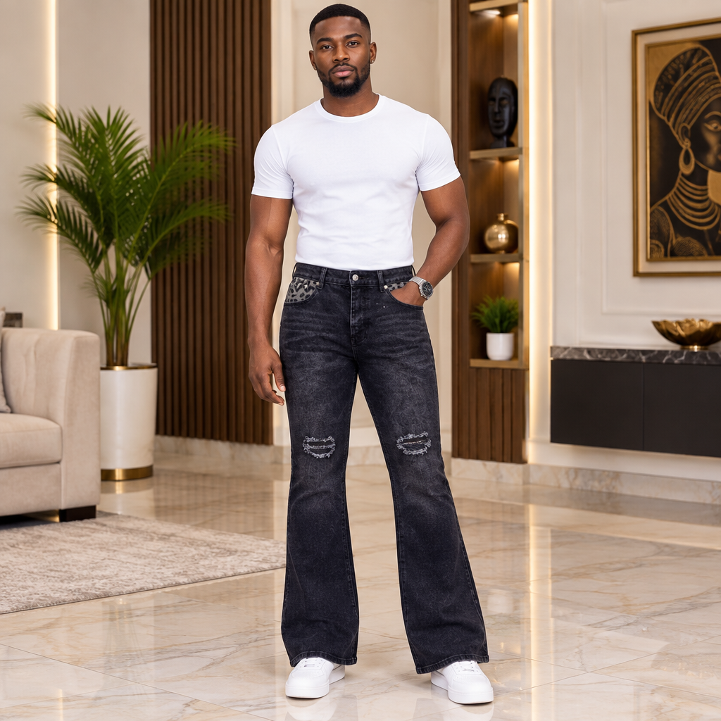 Man wearing washed-black distressed bootcut jeans