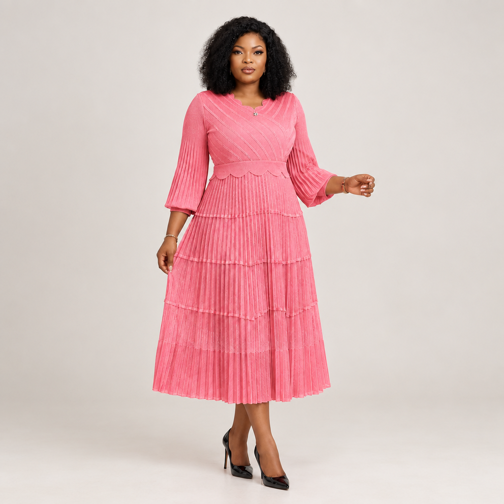 Black Nigerian model wearing a pink tiered pleated gown with bell sleeves and a scalloped neckline