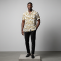 Nigerian male model wearing white gold baroque print short-sleeved shirt, front view