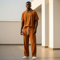Male model wearing cognac gold tassel ribbed polo and trouser two-piece set