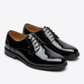Pair of high-shine black plain-toe derby shoes on white