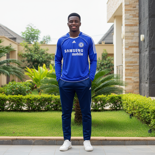 Royal blue long-sleeve retro football jersey with white shoulder stripes — Nigerian male model front view