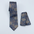 Navy-blue and gold floral tie and matching pocket square on a neutral background