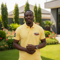 Nigerian male model wearing yellow polo shirt with equestrian embroidery in garden setting