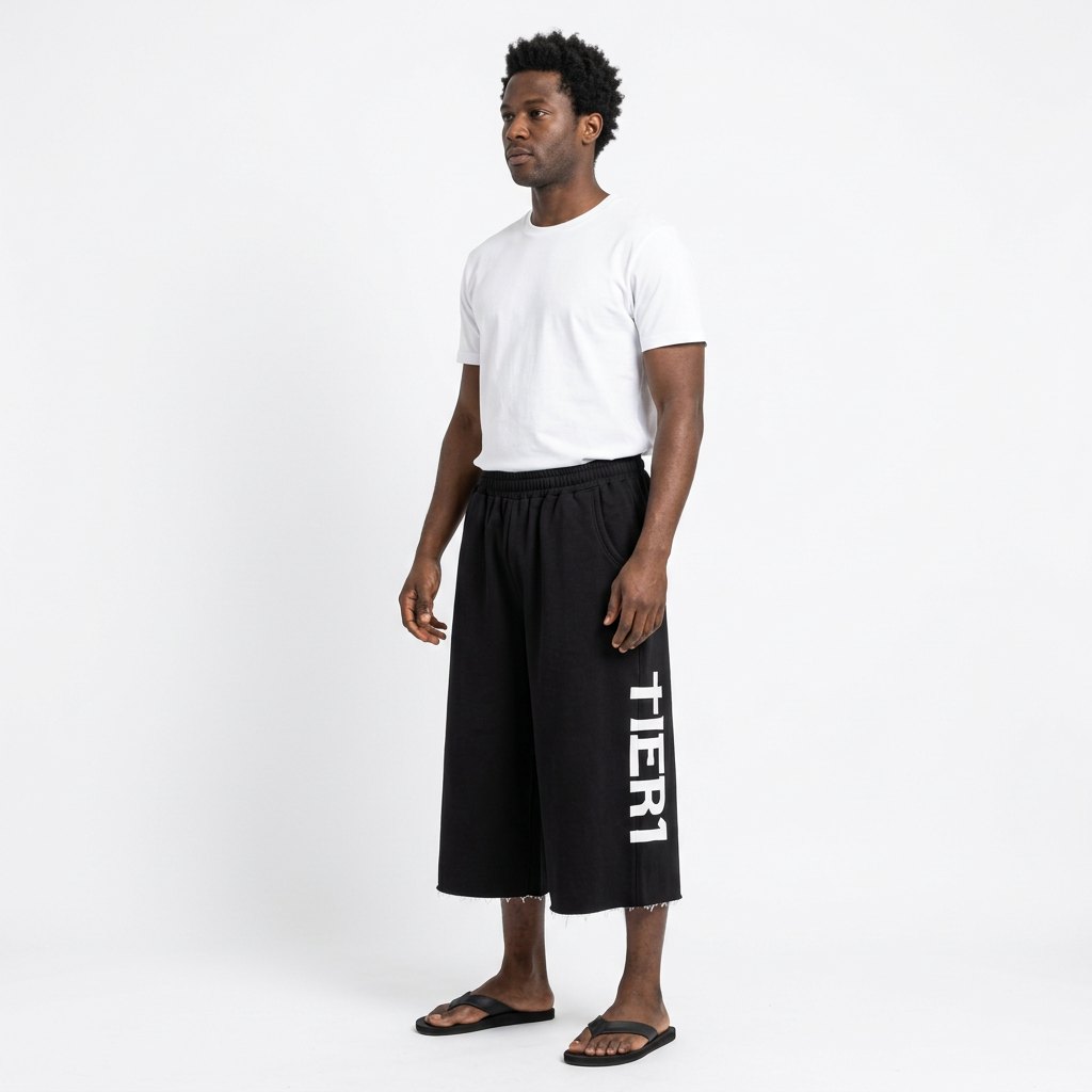 Full-body adult Black man wearing black white-graphic wide-leg long shorts