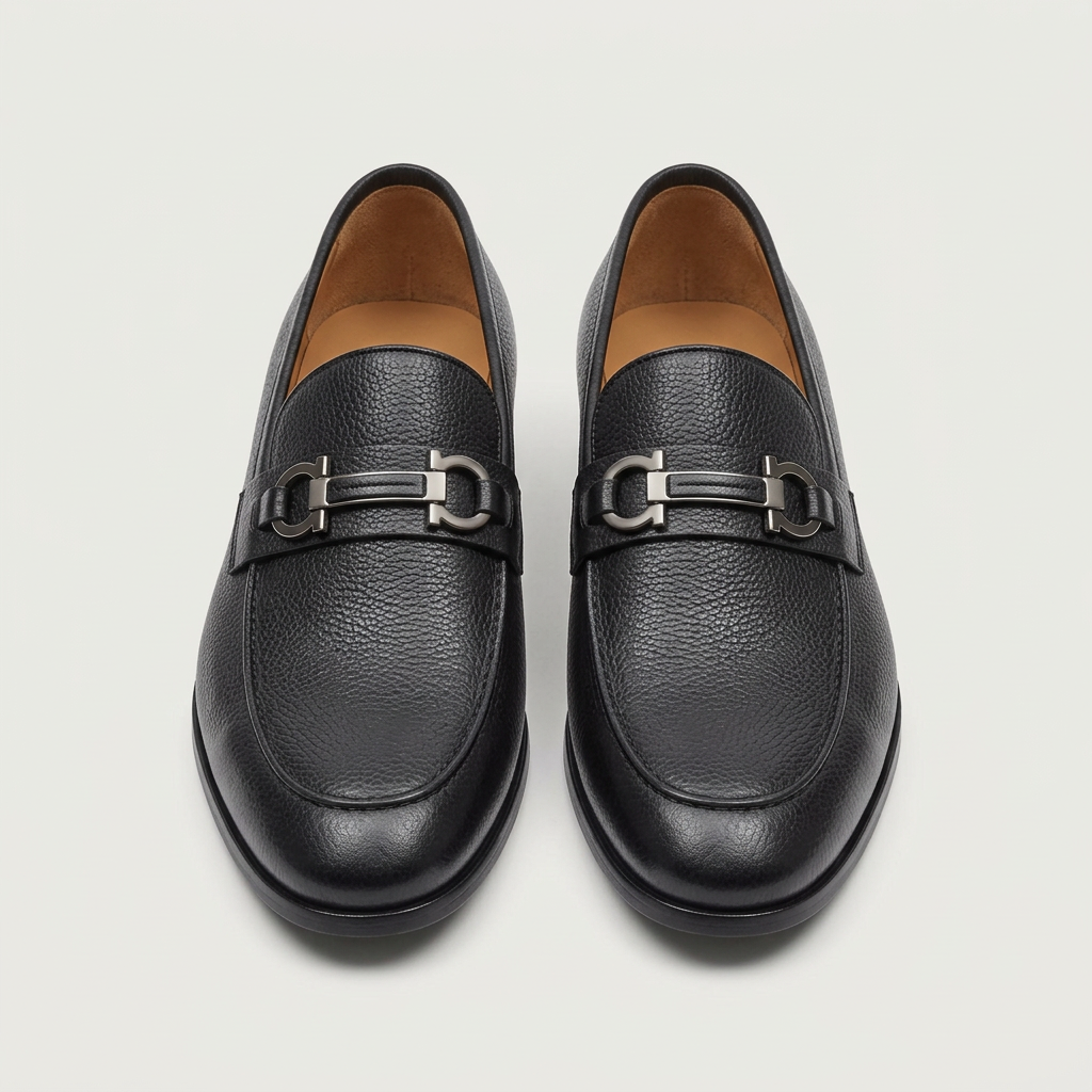 Men's black leather loafers with silver-toned buckle detail, front view