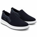 Pair of dark navy slip-on sneakers with white midsoles on white