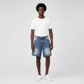 Man wearing the studded faded denim shorts