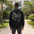 Nigerian male model wearing black sweatshirt with bubble letter cartoon back graphic – back view