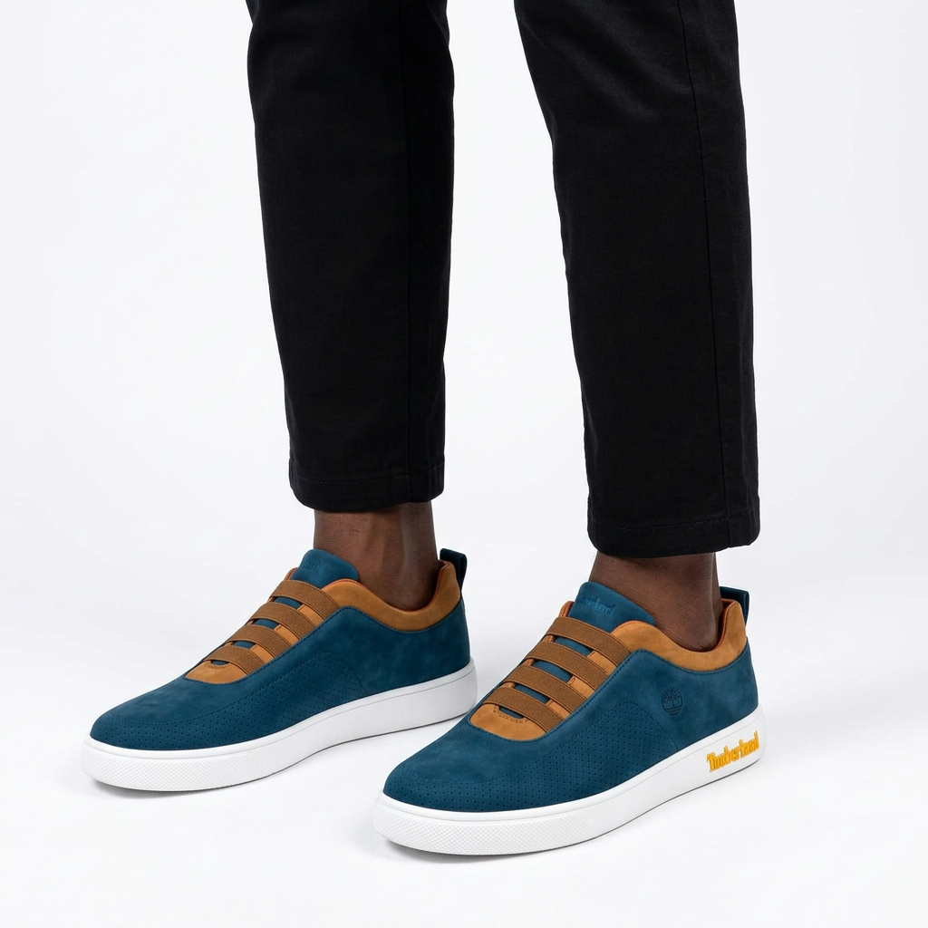 Teal tan-trim elastic-band sneakers properly worn on both feet
