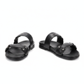 Pair of black double-strap flat slide sandals with silver stud accents on white background