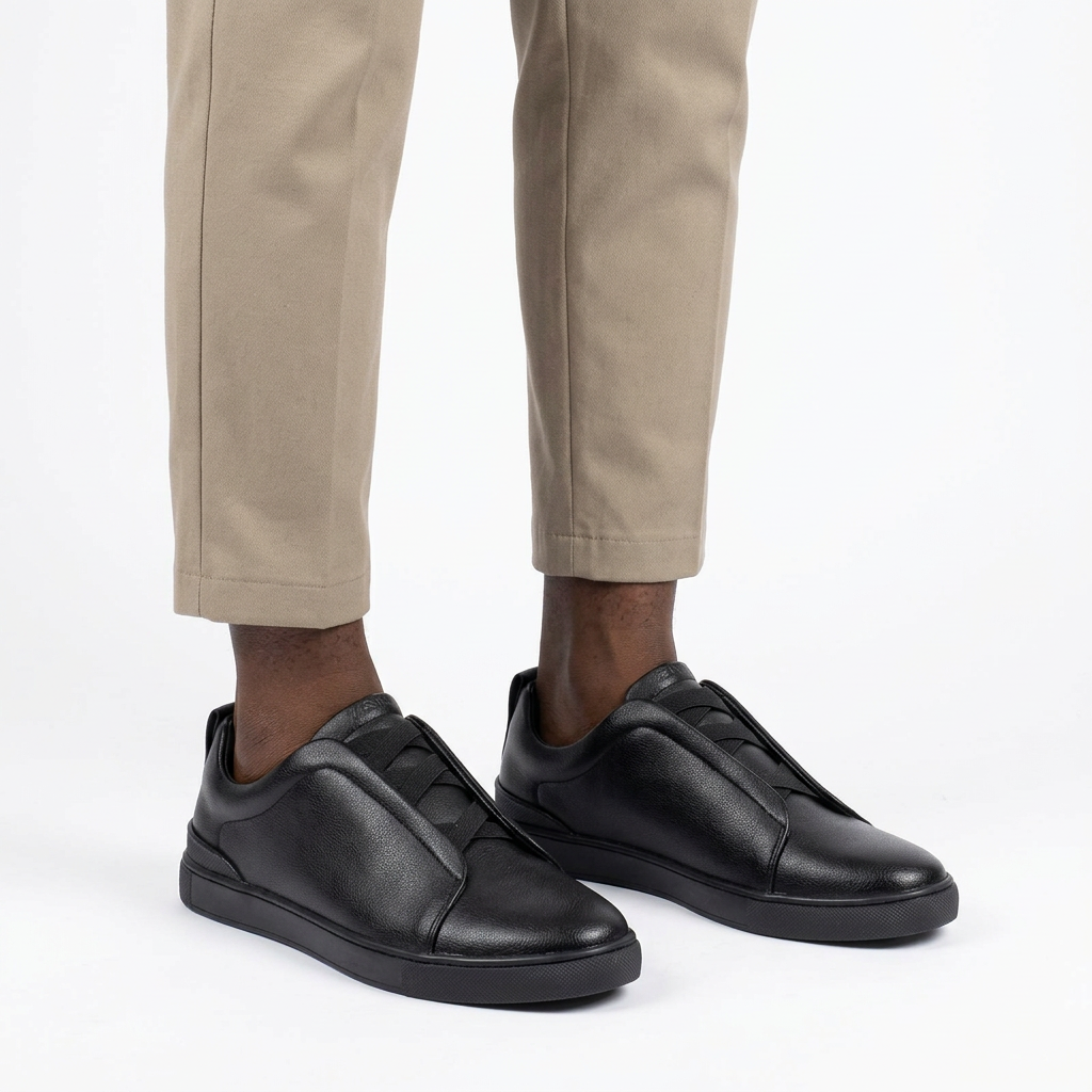 Man wearing black panelled lace-up shoes, both feet visible