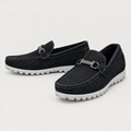 Black textured loafers with silver-tone vamp hardware and rugged white soles