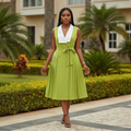 Women's sleeveless white-collar belted pleated midi dress in lime green – Nigerian female model front view